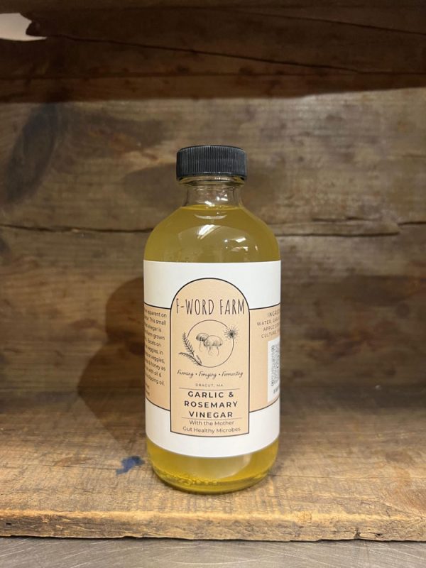 Garlic & Rosemary Vinegar from F-Word Farm, featuring a blend of rosemary and garlic with a nutty aftertaste. Ideal for salad dressings, marinades, dipping oils, and as a topping for garlic green beans, winter squash, and cooked vegetables.